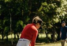 Golfer checking scorecard to calculate handicap