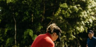 How to Calculate Your Golf Handicap: Simple Guide for Beginners Golfer checking scorecard to calculate handicap