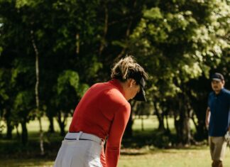 How to Calculate Your Golf Handicap: Simple Guide for Beginners Golfer checking scorecard to calculate handicap