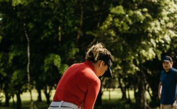 How to Calculate Your Golf Handicap: Simple Guide for Beginners Golfer checking scorecard to calculate handicap